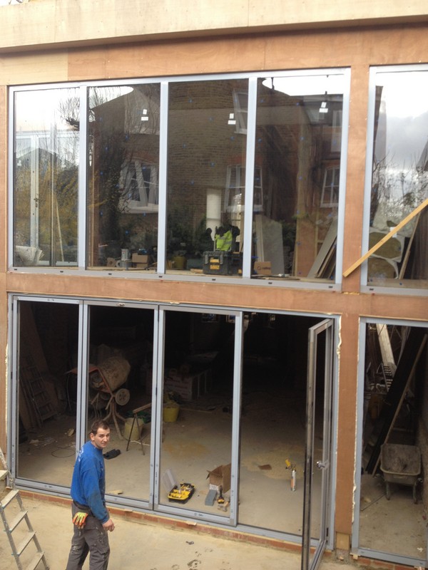 Aluminium bi-fold doors with two-storey glazing in Coulsdon