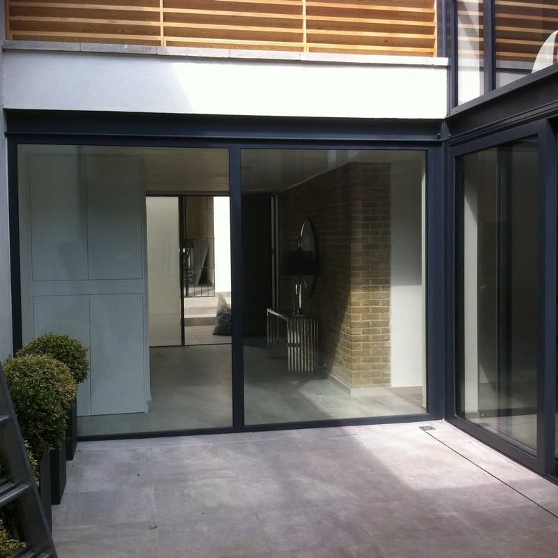Floor-to-ceiling sliding doors opening to courtyard in Coulsdon