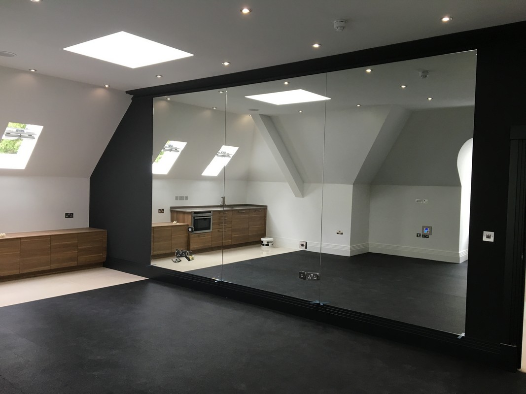 Frameless glass wall dividing loft conversion in Coulsdon