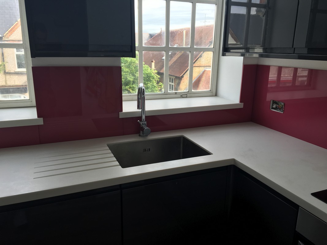 Deep plum coloured glass splashback in modern Coulsdon kitchen