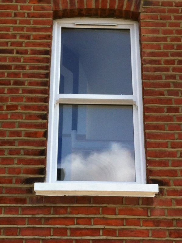 uPVC sash window on Victorian red brick house in Coulsdon